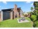 Backyard with a brick fireplace with outdoor seating and a dining table in a landscaped yard at 13207 N 55Th Ave, Glendale, AZ 85304