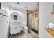 Bright, modern bathroom with shiplap walls, stone counter and glass shower at 13207 N 55Th Ave, Glendale, AZ 85304