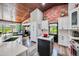 Bright kitchen featuring white cabinets, stainless steel appliances, brick accent wall, and center island at 13207 N 55Th Ave, Glendale, AZ 85304