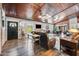 Cozy living room with a wood ceiling, brick accent, and comfortable leather seating at 13207 N 55Th Ave, Glendale, AZ 85304