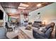 Spacious living area featuring a wood ceiling, comfortable seating, and a view into dining and kitchen at 13207 N 55Th Ave, Glendale, AZ 85304
