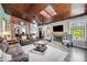 Open-concept living room with a wood ceiling, fireplace, and inviting seating arrangement at 13207 N 55Th Ave, Glendale, AZ 85304