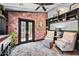 Cozy office space featuring a brick wall, French doors, and comfortable seating at 13207 N 55Th Ave, Glendale, AZ 85304