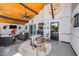 Spacious covered patio with a ceiling fan, bar area, comfortable seating, TV, and rustic décor at 13207 N 55Th Ave, Glendale, AZ 85304