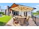 Outdoor patio area with a large dining table, covered pergola, outdoor kitchen and fireplace at 13207 N 55Th Ave, Glendale, AZ 85304