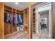 Well-organized walk-in closet with built-in shelving and clothes racks, leading to bedroom at 13207 N 55Th Ave, Glendale, AZ 85304