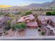 Stunning aerial view of the home in a desert neighborhood surrounded by mountains and scenic views at 14056 E Desert Cove Ave, Scottsdale, AZ 85259