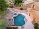 A beautiful home with a private backyard featuring a custom pool, spa, cascading waterfalls, and desert landscaping at 14056 E Desert Cove Ave, Scottsdale, AZ 85259