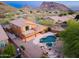 Aerial view of a home's backyard featuring a pool, spa, and mountain views at 14056 E Desert Cove Ave, Scottsdale, AZ 85259