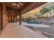 A covered patio provides a scenic view of a private pool and the sunset in the distance at 14056 E Desert Cove Ave, Scottsdale, AZ 85259
