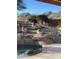 Beautiful backyard with a large pool, rock waterfall feature and stone stairs to enjoy the views at 14056 E Desert Cove Ave, Scottsdale, AZ 85259