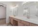 Bright bathroom with dual sinks, vanity, and tile flooring with neutral color palette at 14056 E Desert Cove Ave, Scottsdale, AZ 85259