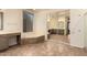 Bright bathroom with bathtub, vanity with makeup counter and large mirrors at 14056 E Desert Cove Ave, Scottsdale, AZ 85259