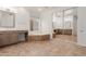 Spacious bathroom with dual vanity sinks, a bathtub, and a large mirror at 14056 E Desert Cove Ave, Scottsdale, AZ 85259