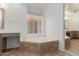 Bathroom with corner tub, tile surround, and a vanity area with space for seating at 14056 E Desert Cove Ave, Scottsdale, AZ 85259