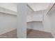 Walk-in closet with ample shelving and rods for organized storage solutions at 14056 E Desert Cove Ave, Scottsdale, AZ 85259