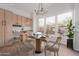 Bright dining area with a table set for four, large windows, and stylish light fixture at 14056 E Desert Cove Ave, Scottsdale, AZ 85259