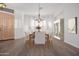 Elegant dining room with a wood table, seating for six, and a charming chandelier at 14056 E Desert Cove Ave, Scottsdale, AZ 85259