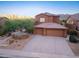 Beautiful two-story home featuring a three-car garage and low-maintenance desert landscaping at 14056 E Desert Cove Ave, Scottsdale, AZ 85259