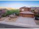 Stunning two-story home featuring a three-car garage and low-maintenance desert landscaping at 14056 E Desert Cove Ave, Scottsdale, AZ 85259