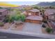 Aerial view of desert home with mature landscaping, an inviting front walkway, and a three-car garage at 14056 E Desert Cove Ave, Scottsdale, AZ 85259
