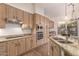 Bright kitchen features stainless appliances, ample cabinetry and stone countertops at 14056 E Desert Cove Ave, Scottsdale, AZ 85259
