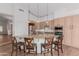 Open-concept kitchen with an island, granite countertops, pendant lights, and stainless steel appliances at 14056 E Desert Cove Ave, Scottsdale, AZ 85259
