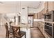 Bright kitchen featuring a granite island with bar seating and stainless steel appliances at 14056 E Desert Cove Ave, Scottsdale, AZ 85259