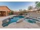 Resort-style backyard with a sparkling pool, spa, desert landscaping, and covered patio for ultimate relaxation at 14056 E Desert Cove Ave, Scottsdale, AZ 85259