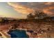 An inviting pool and spa, nestled amidst desert landscaping and scenic views, offer a tranquil backyard retreat at 14056 E Desert Cove Ave, Scottsdale, AZ 85259