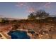 Backyard features a sparkling pool with a serene desert landscape and night sky at 14056 E Desert Cove Ave, Scottsdale, AZ 85259