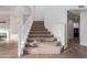 Inviting staircase with carpeted steps and a white railing, leading to the upper level at 14056 E Desert Cove Ave, Scottsdale, AZ 85259