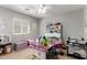 Playful bedroom with ample natural light, a ceiling fan, and decorative furniture pieces at 14112 W Larkspur Dr, Surprise, AZ 85379