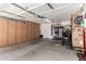 Spacious garage with ample storage cabinets for organization and a door to the outside at 14112 W Larkspur Dr, Surprise, AZ 85379