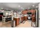 Spacious kitchen with stainless steel appliances, wooden cabinetry, and stylish decor at 14112 W Larkspur Dr, Surprise, AZ 85379