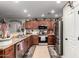 Well-lit kitchen featuring stainless steel appliances, wood cabinets, and modern finishes at 14112 W Larkspur Dr, Surprise, AZ 85379