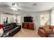 Inviting living room with a comfortable sofa, tiled floor, and ample natural light at 14112 W Larkspur Dr, Surprise, AZ 85379