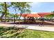 Community playground with shaded play structures and open space for recreation at 14112 W Larkspur Dr, Surprise, AZ 85379