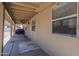 Tan covered back patio showcasing an open space for entertaining, complemented by neutral-colored siding and flooring at 1519 E Indian Wells Dr, Chandler, AZ 85249