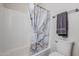 Clean bathroom area featuring a shower with patterned curtain and a matching towel at 1519 E Indian Wells Dr, Chandler, AZ 85249