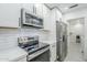 Modern kitchen showcases stainless steel appliances, white cabinets, and subway tile backsplash at 1519 E Indian Wells Dr, Chandler, AZ 85249