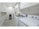 Functional laundry room features built-in shelves, washer, dryer, and water dispenser, providing convenience at 1519 E Indian Wells Dr, Chandler, AZ 85249