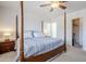 Comfortable bedroom includes a four-poster bed, ceiling fan, and ensuite access to enhance daily living at 1519 E Indian Wells Dr, Chandler, AZ 85249