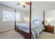 Cozy bedroom featuring a four-poster bed, ceiling fan, and natural light for a peaceful retreat at 1519 E Indian Wells Dr, Chandler, AZ 85249