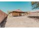 Large backyard with a covered patio and block wall fencing, suitable for outdoor activities at 15701 N Bonow Dr, Surprise, AZ 85374
