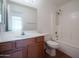 Bright bathroom with a vanity, toilet, and shower-tub combination with white tile surround at 15701 N Bonow Dr, Surprise, AZ 85374
