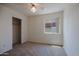 A bedroom with neutral carpet and walls, a ceiling fan, and a closet with sliding doors at 15701 N Bonow Dr, Surprise, AZ 85374