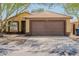 Charming one-story home featuring a desert landscaped yard, a two-car garage, and a front entry at 15701 N Bonow Dr, Surprise, AZ 85374