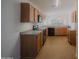 Well-lit kitchen features oak cabinets, laminate countertops, and modern appliances at 15701 N Bonow Dr, Surprise, AZ 85374