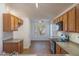 Traditional kitchen features oak cabinets, laminate countertops, and wood-look vinyl flooring at 15701 N Bonow Dr, Surprise, AZ 85374